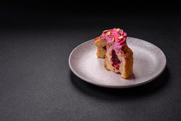 Sweet craffin or panettone garnished with raspberry and pistachio flavored cream