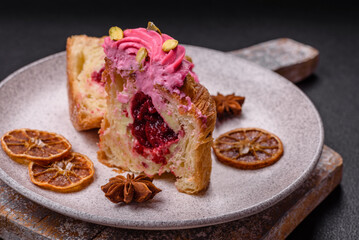 Sweet craffin or panettone garnished with raspberry and pistachio flavored cream