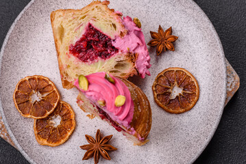Sweet craffin or panettone garnished with raspberry and pistachio flavored cream