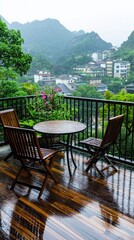Obraz premium Rain falls gently on the balcony, creating a tranquil atmosphere while vibrant flowers and lush greenery frame the picturesque view of the mountainous village below