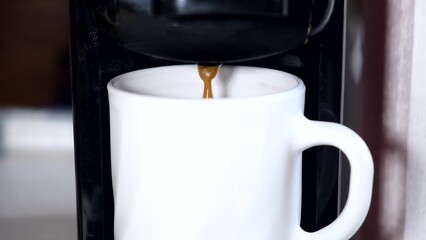 Capsule coffee machine pouring out espresso shot close up