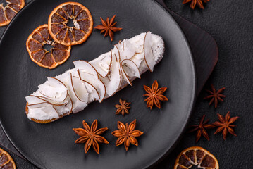 Sweet eclair with custard decorated with coconut slices