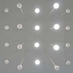 Luminous lamps with a symmetrical ensemble on the ceiling in the room