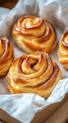 Fototapeta premium Warm cinnamon rolls sit invitingly in a dish, drizzled with creamy icing, creating a delicious breakfast treat perfect for sharing with friends and family