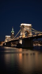 Obraz premium Cityscape featuring iconic bridge at night with shimmering reflections