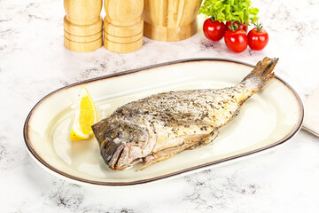 Baked Dorado fish served lemon