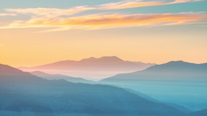 Obraz premium A serene landscape of layered mountains during sunset.