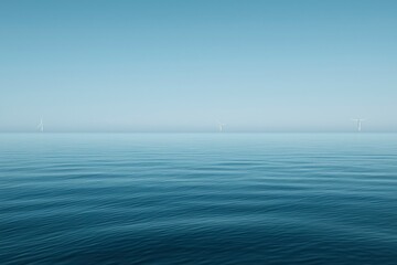 Obraz premium Three Wind Turbines Standing in a Calm Sea
