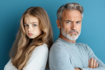 Upset father and daughter positioned back-to-back, their arms crossed in silence, illustrating the strain in their relationship caused by her choice of a court marriage.