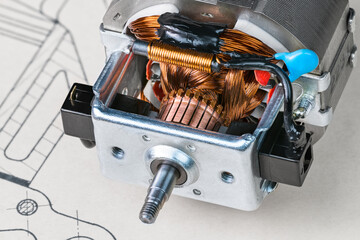 Electric DC motor rotor commutator and stator ferromagnetic sheets. Carbon brushes, copper wire of choke on cable and blue capacitor or shaft in plain bearing inside electromotor on technical drawing.