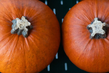 A close-up of fresh orange pumpkins, perfect for carving for Halloween and autumn celebrations. The...