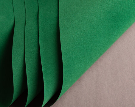 Paper texture background. Premium designer sheet with deep emerald shade and curved, wavy layers. Elegant, modern structure with felt textile and flocked material. Chic monochrome