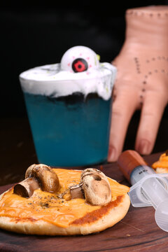 Naklejki halloween idea funny and horrifying dishes two mini pizza with skull on mushroom with sauce in syringe drink blue curaçao with blurred eye