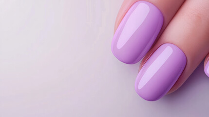Elegant purple nail polish applied to well-manicured fingers, showcasing a beautiful finish on a neutral backdrop