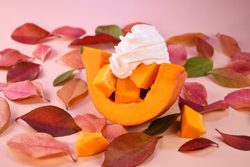 fresh whole pumpkin, pieces of pumpkin on a background of autumn leaves. Autumn background.