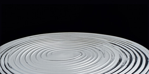 Fototapeta premium Abstract close-up of concentric ripple patterns on black background