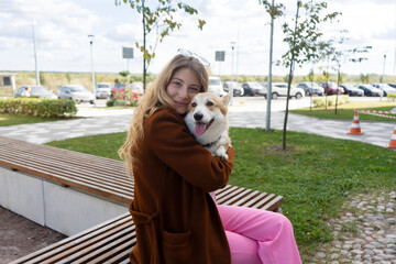 Best friends. Happy young woman girl hugs her cute beloved corgi dog puppy. Lovely pets.