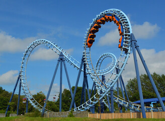 Roller coaster  ride filled  with thrill seekers 