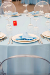 Beautiful table setting for a party, wedding reception or other festive event. Glassware and cutlery for catered event dinner