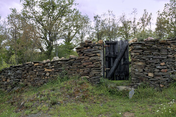 Wall made of slate stone with a wooden gate