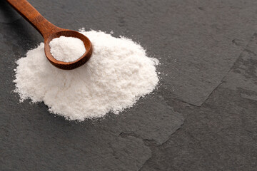 Baking soda powder in spoon - Healthy food.