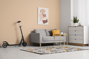 Interior of living room with electric scooter, sofa and table