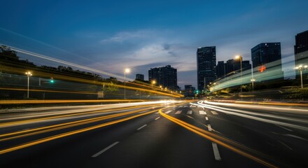 Obraz premium Cityscape with streaks of light from moving vehicles, tall buildings in background during twilight