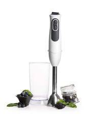 Modern blender with berries and basil on white background
