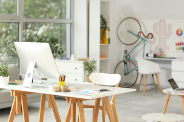 Graphic designer's workplace with computer monitor in office