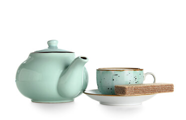 Ceramic teapot with cup and waffle on white background