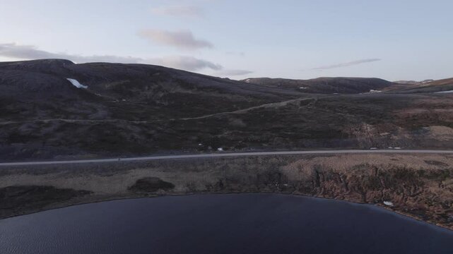 A cyclist rides on the road to North Cape in Norway., D-Log for better color grading