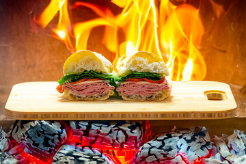 Italian mortadella bologna sandwich with arugula, tomato and cheese on ciabatta bread