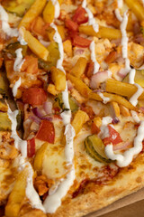 pizza with pickled cucumbers and French fries