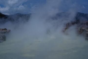 The Sikidang crater in Dieng features a greenish, acidic pool