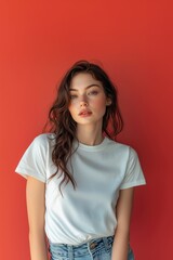 Obraz premium Hair Model Smiling and Wearing a Blank T-shirt Standing in Front of a Red Background, Print on Demand Template, Fashion Portrait Mockup, People Wearing Clothing with Print Copy Space
