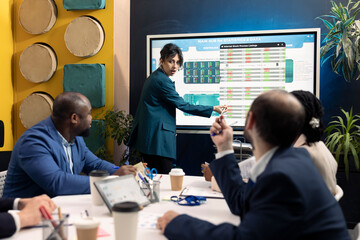 Corporate workmates looking into project insight and details in conference room, establishing budget and operations plan to accomplish goals in a competitive environment.