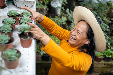 Mexican woman smiling while taking care of plants