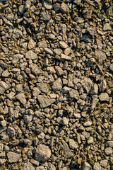 Rubble and rocks scattered along a shore, emphasizing coastal erosion and rugged landscape.
