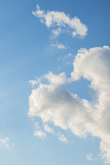 Expansive sky with soft clouds forming abstract patterns, creating a calm and peaceful atmosphere.

