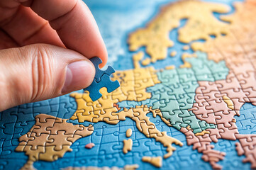 close up of a hand holding a piece of a puzzle with the map of europe, concept of european union or disintegration of the union