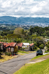 Village road street through land forest town mountains Costa Rica.
