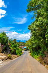 Village road path through land forest with mountains Costa Rica.