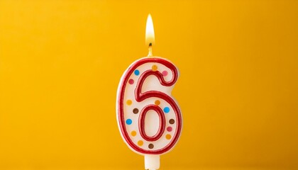 Six number. Number 6 birthday cake celebration candle against a bright yellow background.