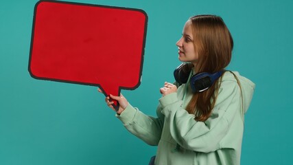 Smiling woman holding red speech bubble sign of empty copy space for message. Joyous teenager...