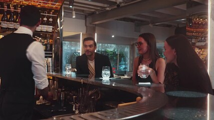 Serving special drink gin fizz of mixed cocktail to smiling VIP customer with couple or friend group by smart bartender service at beverage counter bar luxury nightlife at nightclub party. Vinosity.