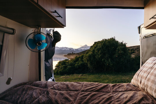 Getting up in a motorhome or camper van with amazing view of Lake Huechulafquen and Lanin volcano. Patagonia, Argentina