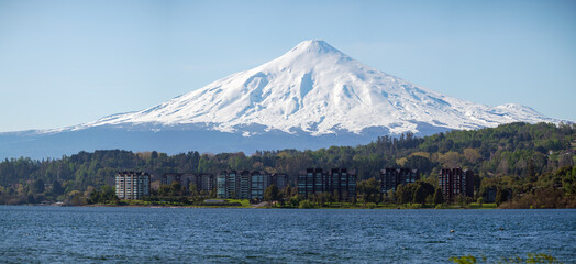 Majestic Villarrica snow-capped volcano resting above lake. Wide angle view © Pajaros Volando