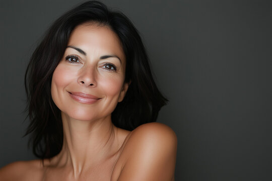 Beautiful middle age natural woman with perfect skin on neutral background with space for text, skincare concept