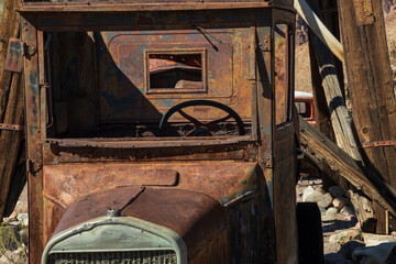 Abandoned vintage rusted vehicle in a desert junkyard