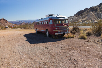Abandoned vintage rusted vehicle in a desert junkyard
